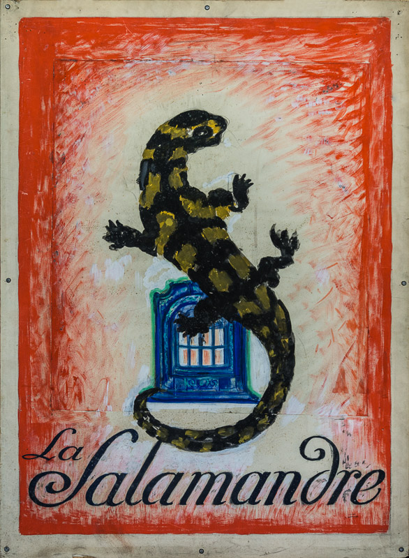 1927 - A giant salamander warms itself against a stove.