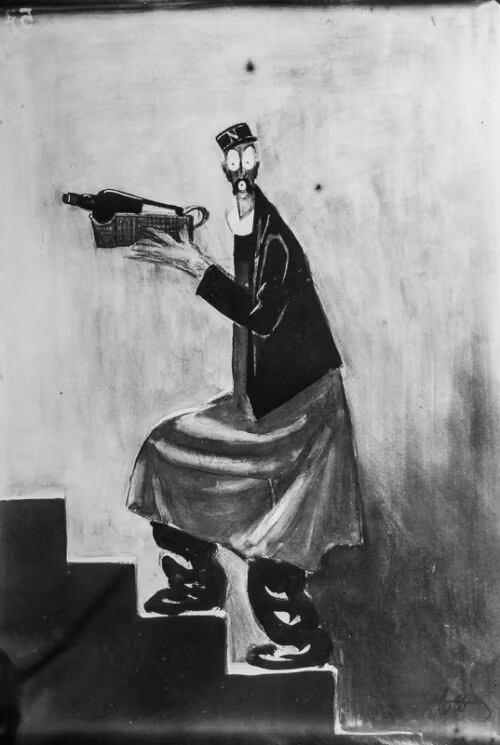 1929 - A man in a dressing gown carefully brings up an excellent bottle of wine from the cellar.
